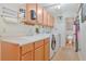 Functional laundry room with washer, dryer, utility sink, and ample cabinet storage at 2136 Bendway Dr, Port Charlotte, FL 33948