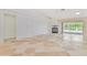Spacious living room with fireplace and access to the outdoor pool area at 2136 Bendway Dr, Port Charlotte, FL 33948