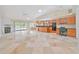 Spacious living area featuring tile floors, fireplace, and an open layout connecting to the kitchen and dining area at 2136 Bendway Dr, Port Charlotte, FL 33948
