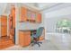 Dedicated office area with built-in desk, cabinets, and a view to the front yard at 2136 Bendway Dr, Port Charlotte, FL 33948