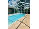 Inviting pool area with a screened enclosure and a spacious deck at 2136 Bendway Dr, Port Charlotte, FL 33948