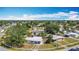 Aerial view of a residential neighborhood with houses and mature landscaping on a sunny day with scattered clouds at 21966 Belinda Ave, Port Charlotte, FL 33952