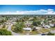 Expansive aerial view of a quiet neighborhood filled with lush trees and well-kept homes at 21966 Belinda Ave, Port Charlotte, FL 33952