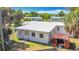 Aerial view shows house with white roof, small shed, and dry lawn in the backyard at 21966 Belinda Ave, Port Charlotte, FL 33952