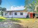 Backyard features dry lawn, small shed, and vinyl siding on the house exterior at 21966 Belinda Ave, Port Charlotte, FL 33952