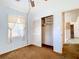 This bedroom features bright natural lighting and an open closet for storage at 21966 Belinda Ave, Port Charlotte, FL 33952
