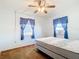 Cozy bedroom features two windows and a ceiling fan at 21966 Belinda Ave, Port Charlotte, FL 33952