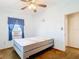 Bedroom features white walls, carpeting, a window with curtains, ceiling fan, and a twin bed at 21966 Belinda Ave, Port Charlotte, FL 33952