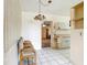 Dining area with tile flooring, neutral walls, and a vintage light fixture at 21966 Belinda Ave, Port Charlotte, FL 33952