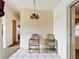 Dining area with tile flooring, neutral walls, and a vintage light fixture at 21966 Belinda Ave, Port Charlotte, FL 33952