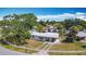 Charming single-story home featuring a carport, mature landscaping, and a well-maintained front yard at 21966 Belinda Ave, Port Charlotte, FL 33952
