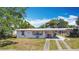Charming single story home with a covered carport and a well-manicured front lawn at 21966 Belinda Ave, Port Charlotte, FL 33952
