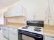 This kitchen features white appliances and cabinets and light countertops at 21966 Belinda Ave, Port Charlotte, FL 33952