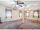 Open living room features carpet, ceiling fans and bright natural lighting at 21966 Belinda Ave, Port Charlotte, FL 33952