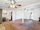 Open living room with ceiling fans and sliding door to an adjacent room at 21966 Belinda Ave, Port Charlotte, FL 33952