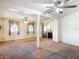 Open living room with ceiling fans, beige carpet, and sliding door to backyard at 21966 Belinda Ave, Port Charlotte, FL 33952