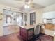 This office features a large desk, ceiling fan, window AC, and sliding door to the main living area at 21966 Belinda Ave, Port Charlotte, FL 33952