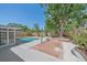 Expansive backyard oasis with a swimming pool, mature trees, and a brick patio at 2226 Fairfield Ave, Sarasota, FL 34232