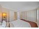 Cozy bedroom featuring wood floors, a large bed, and ample closet space at 2226 Fairfield Ave, Sarasota, FL 34232