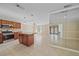 Eat-in kitchen with an island, wood cabinets, tile floors, and easy access to dining and backyard views at 2226 Fairfield Ave, Sarasota, FL 34232
