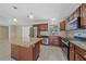 Well-lit kitchen features stainless steel appliances, granite countertops, and an island with pendant lighting at 2226 Fairfield Ave, Sarasota, FL 34232