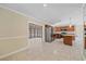 Open-concept kitchen and dining area with stainless steel appliances, tile floors, and access to sunroom at 2226 Fairfield Ave, Sarasota, FL 34232