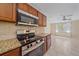 Modern kitchen with granite counters, stainless steel appliances, and tile backsplash, leading to an open floorplan at 2226 Fairfield Ave, Sarasota, FL 34232