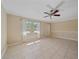 Bright living room featuring a ceiling fan, large window, and tile floors at 2226 Fairfield Ave, Sarasota, FL 34232