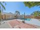 Relaxing backyard pool area featuring a brick patio and well-maintained landscaping at 2226 Fairfield Ave, Sarasota, FL 34232