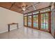 Bright sunroom with tile flooring and a stunning view of the outdoor swimming pool through french doors at 2226 Fairfield Ave, Sarasota, FL 34232