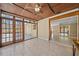 Bright sunroom with tile floor, multiple windows and a ceiling fan at 2226 Fairfield Ave, Sarasota, FL 34232