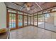 Charming sunroom featuring tiled floors and walls of windows overlooking the pool area at 2226 Fairfield Ave, Sarasota, FL 34232