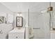 This bathroom has a frameless glass shower, handrails, white marbled tile, modern fixtures, and a built-in seat at 2280 Stickney Point Rd # 420, Sarasota, FL 34231