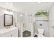 Modern bathroom features a seamless glass shower, pebble flooring, white tile, and stylish fixtures at 2280 Stickney Point Rd # 420, Sarasota, FL 34231