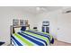 Bright bedroom with coastal-themed bedspread, a ceiling fan, neutral colors, and tile flooring at 2280 Stickney Point Rd # 420, Sarasota, FL 34231