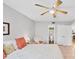 Bright bedroom features a ceiling fan, access to an ensuite bathroom, neutral colors, and comfortable furnishings at 2280 Stickney Point Rd # 420, Sarasota, FL 34231
