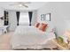 Comfortable bedroom with tile floors and ample natural light, ideal for relaxation at 2280 Stickney Point Rd # 420, Sarasota, FL 34231