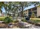 Outdoor seating area with lush landscaping, offering a perfect spot for relaxation and outdoor dining at 2280 Stickney Point Rd # 420, Sarasota, FL 34231