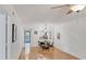 Light-filled dining area featuring hardwood floors, modern light fixture, and convenient access to kitchen at 2280 Stickney Point Rd # 420, Sarasota, FL 34231