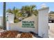 Tregate Manor Condominiums signage amidst lush landscaping on a bright, sunny day at 2280 Stickney Point Rd # 420, Sarasota, FL 34231