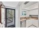 View from entry of kitchen featuring updated appliances, granite countertops, and white cabinetry; creating a modern aesthetic at 2280 Stickney Point Rd # 420, Sarasota, FL 34231