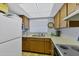 Functional kitchen featuring wood cabinets, a white refrigerator, and essential appliances at 2280 Stickney Point Rd # 420, Sarasota, FL 34231