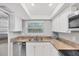 Bright kitchen features white cabinets, granite countertops and stainless steel appliances at 2280 Stickney Point Rd # 420, Sarasota, FL 34231