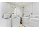 Laundry room features multiple washers and dryers, and a water heater at 2280 Stickney Point Rd # 420, Sarasota, FL 34231