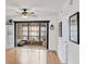 Bright living room featuring hardwood floors, a ceiling fan and a screened patio with outdoor seating at 2280 Stickney Point Rd # 420, Sarasota, FL 34231