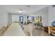 Bright living room with flexible seating arrangements, ceiling fans, and large windows with sunshades at 2280 Stickney Point Rd # 420, Sarasota, FL 34231