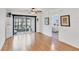 Bright living room features hardwood floors, a ceiling fan, and a screened patio with outdoor seating at 2280 Stickney Point Rd # 420, Sarasota, FL 34231