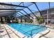 Community pool is enclosed with a screened frame and features multiple chairs and loungers at 2280 Stickney Point Rd # 420, Sarasota, FL 34231