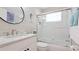Bright bathroom featuring a shower, white vanity with granite countertop and decorative mirror at 2306 64Th W St # 17, Bradenton, FL 34209