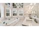 Bright bathroom boasts a soaking tub, granite countertops, and plantation shutters for added privacy at 2306 64Th W St # 17, Bradenton, FL 34209
